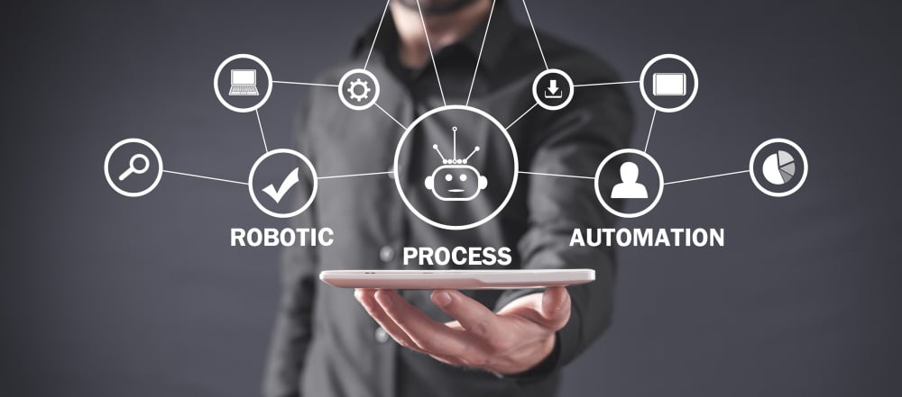 Person holding tablet with icons representing robotic process automation and smart workflows for lead management.